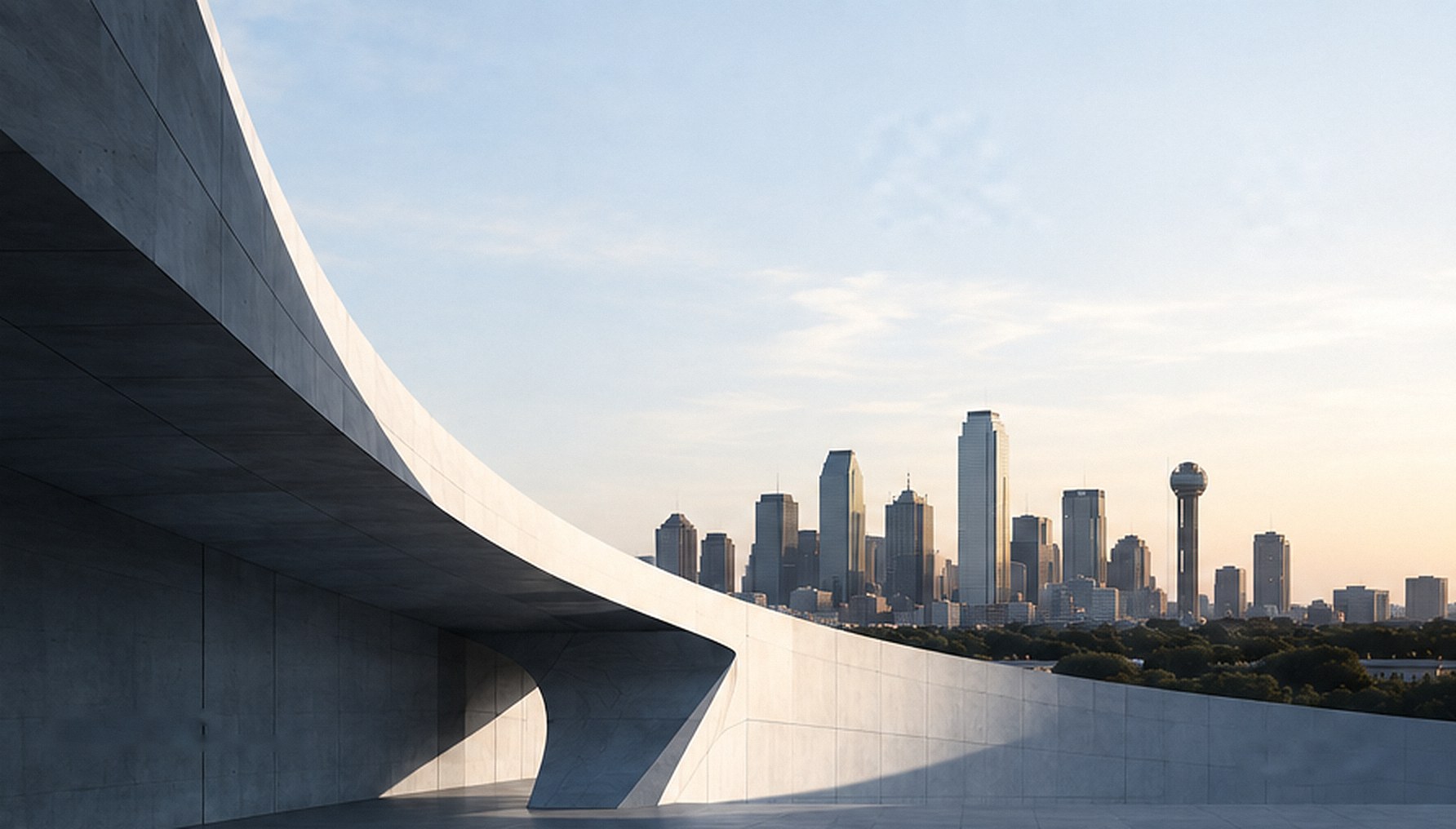 A sweeping concrete structure in front of the Dallas skyline at golden hour
