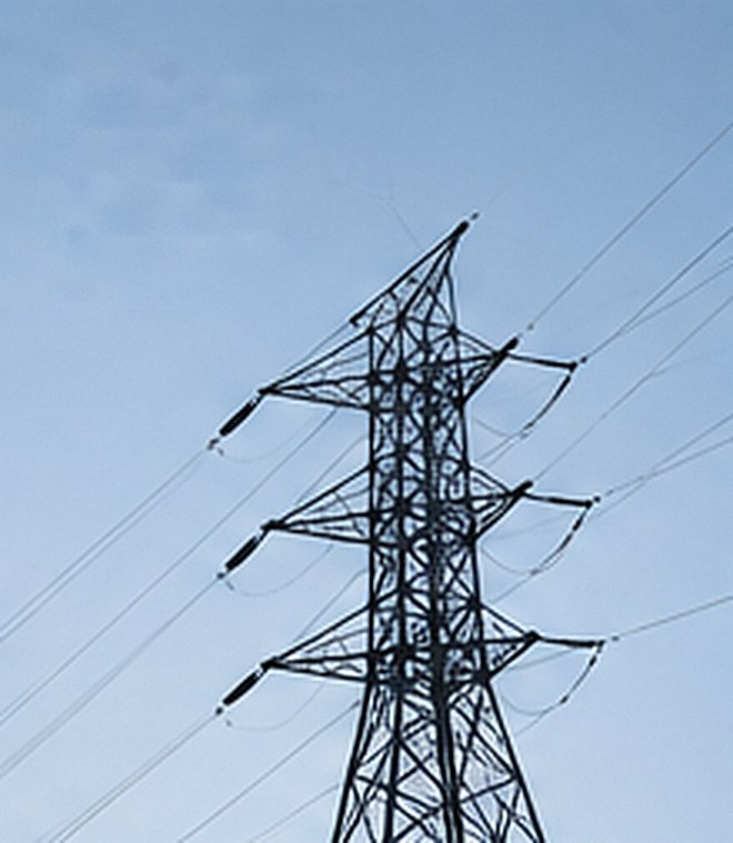 Electricity transmission tower against a clear sky